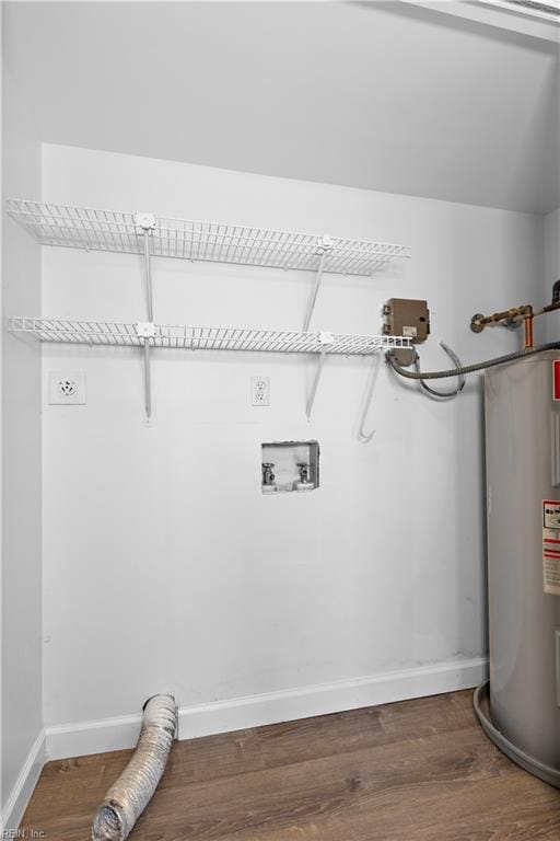 clothes washing area with wood-type flooring, electric dryer hookup, and electric water heater