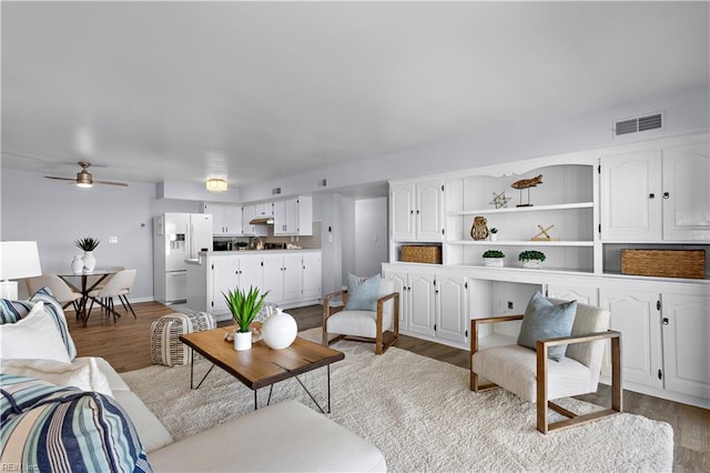 living room with light hardwood / wood-style floors and ceiling fan