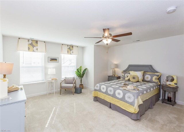 bedroom featuring ceiling fan and carpet