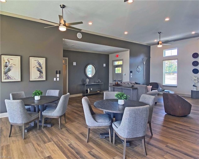 dining area with crown molding, ceiling fan, and dark hardwood / wood-style flooring