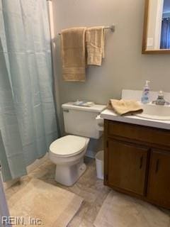 bathroom featuring vanity, a shower with shower curtain, and toilet