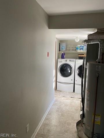 laundry area with water heater and washing machine and clothes dryer