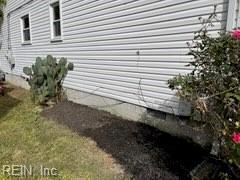 view of side of home featuring a lawn