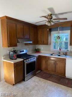 kitchen featuring ceiling fan, stainless steel range with gas cooktop, and sink