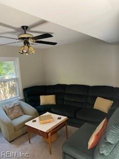 carpeted living room with ceiling fan