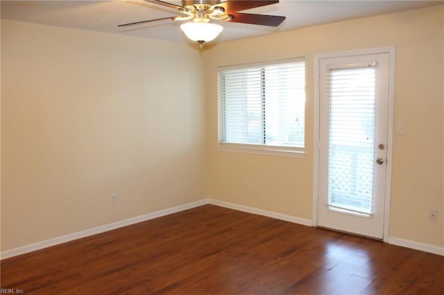 empty room featuring ceiling fan and dark hardwood / wood-style flooring