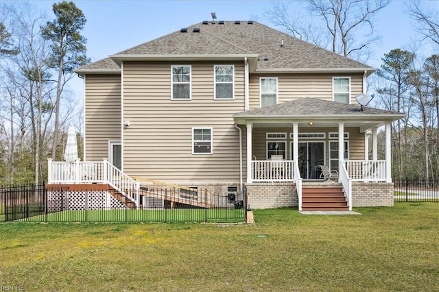 rear view of house featuring a yard