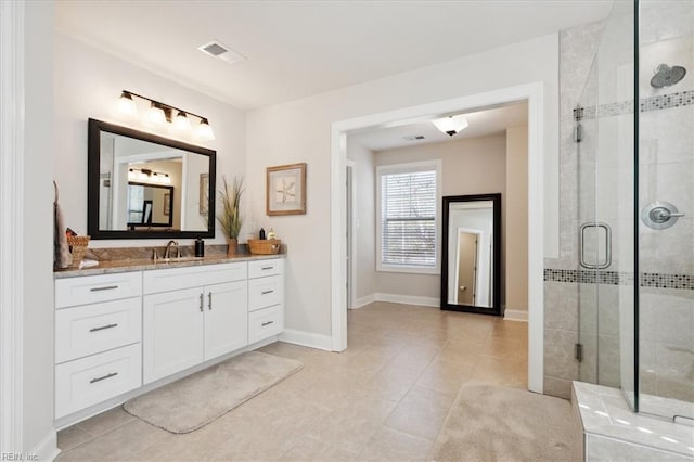 bathroom featuring vanity, an enclosed shower, and tile patterned flooring