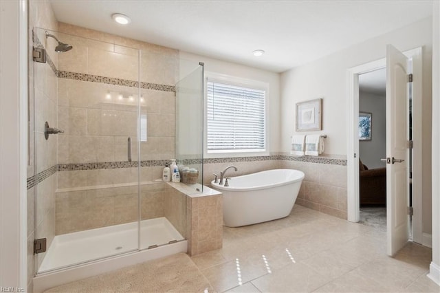 bathroom with tile walls, tile patterned flooring, and plus walk in shower