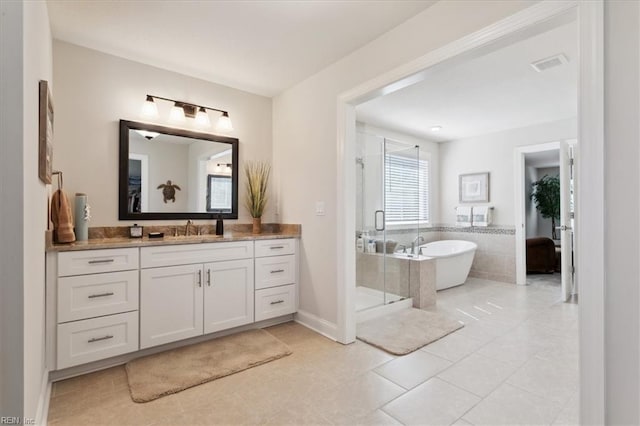 bathroom featuring vanity, shower with separate bathtub, and tile patterned floors