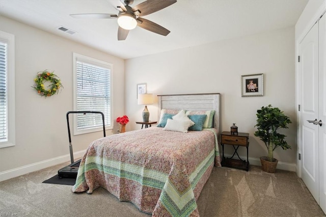 carpeted bedroom with a closet and ceiling fan