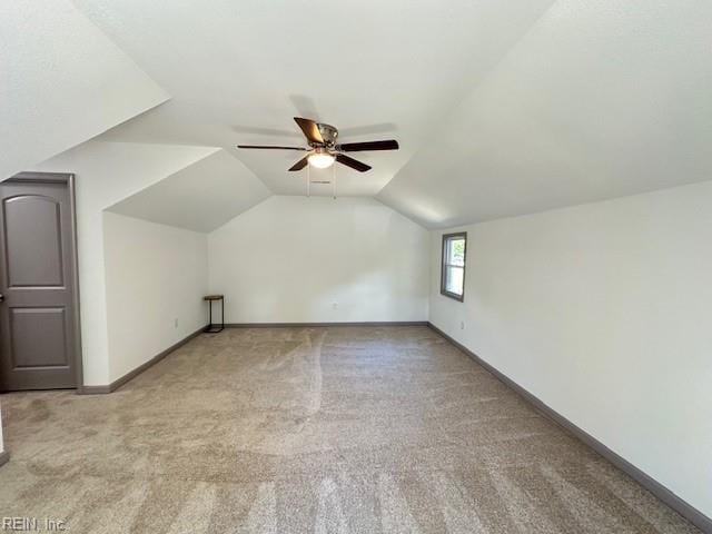 bonus room with light carpet, lofted ceiling, and ceiling fan