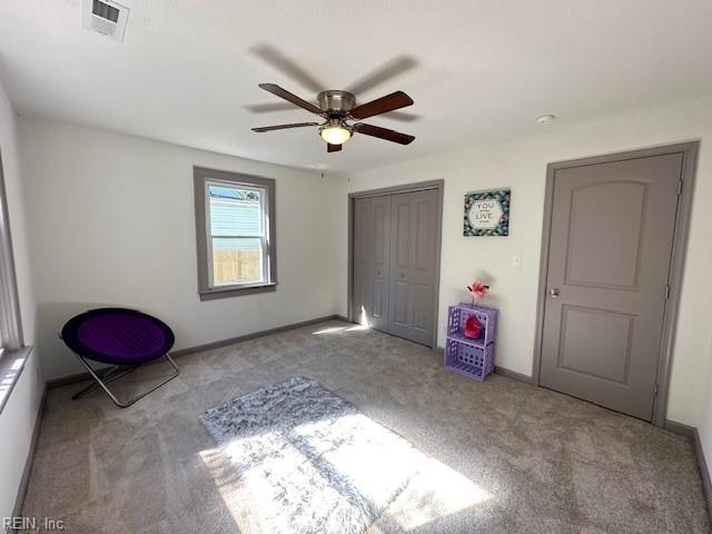 unfurnished bedroom with light carpet, a closet, and ceiling fan