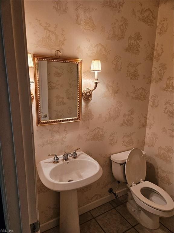 bathroom featuring tile patterned flooring, toilet, and sink