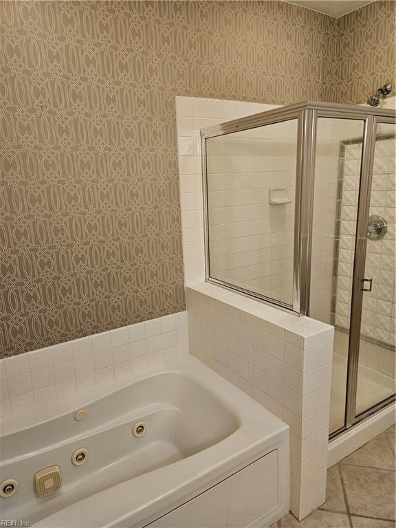 bathroom featuring tile patterned floors and plus walk in shower