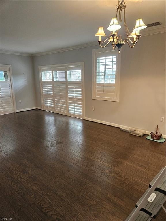 unfurnished room with a chandelier, dark wood-type flooring, and ornamental molding