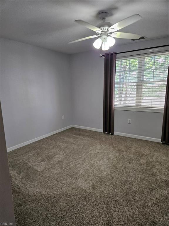 spare room featuring carpet flooring and ceiling fan