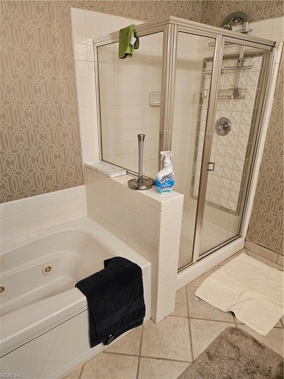 bathroom with tile patterned flooring and independent shower and bath