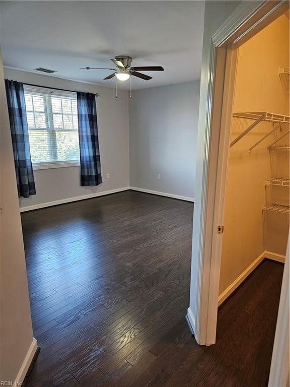 spare room featuring dark hardwood / wood-style floors and ceiling fan