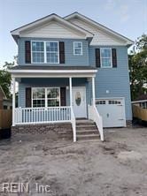 front facade featuring covered porch and a garage