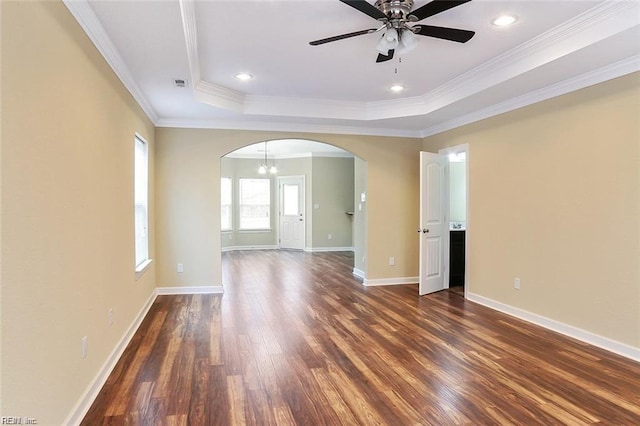 spare room featuring crown molding, ceiling fan, a raised ceiling, and dark hardwood / wood-style flooring