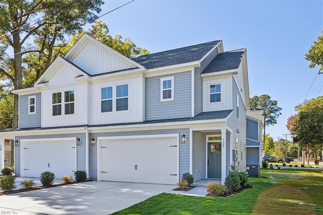 view of front facade featuring central AC, a garage, and a front lawn