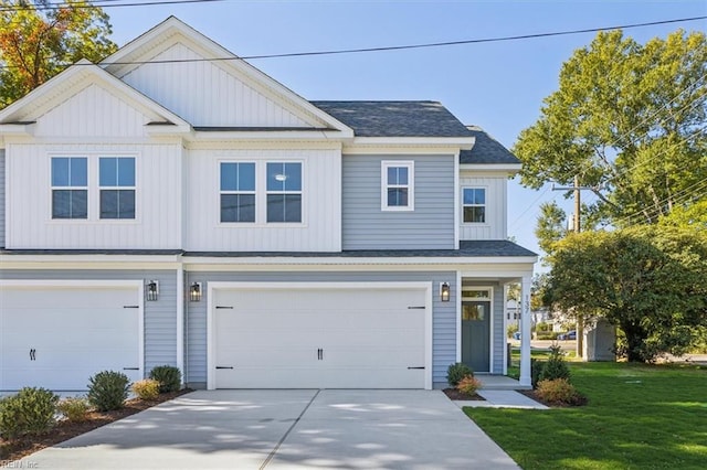 view of front of home with a front yard and a garage