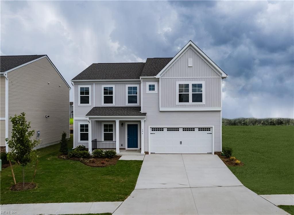 view of front of property with a garage and a front lawn