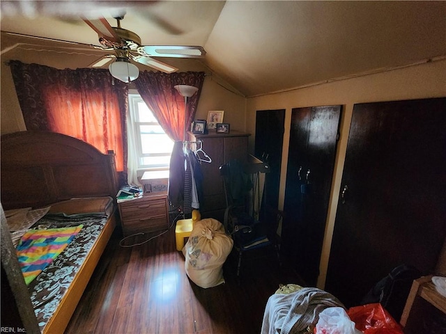 bedroom with ceiling fan, lofted ceiling, and dark hardwood / wood-style flooring