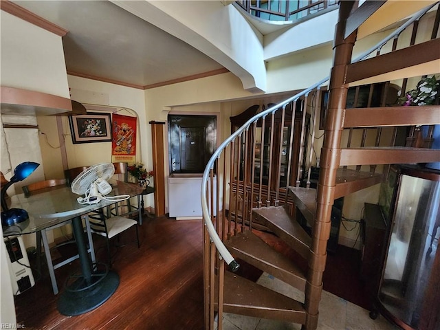 stairway featuring crown molding and hardwood / wood-style floors