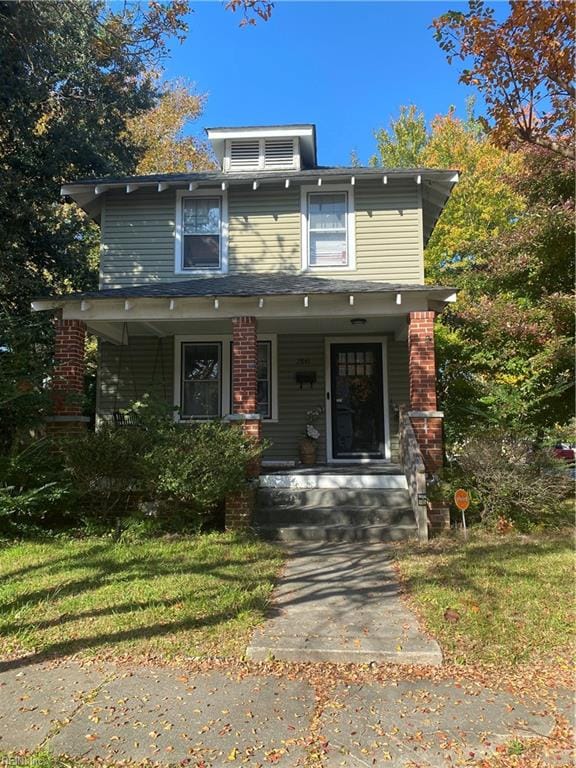 view of front of house with covered porch and a front yard