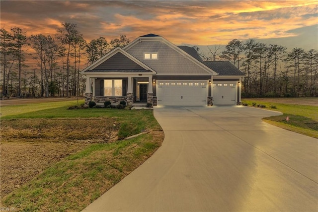 craftsman inspired home featuring a yard and a garage