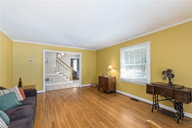 living room featuring crown molding and light wood-type flooring