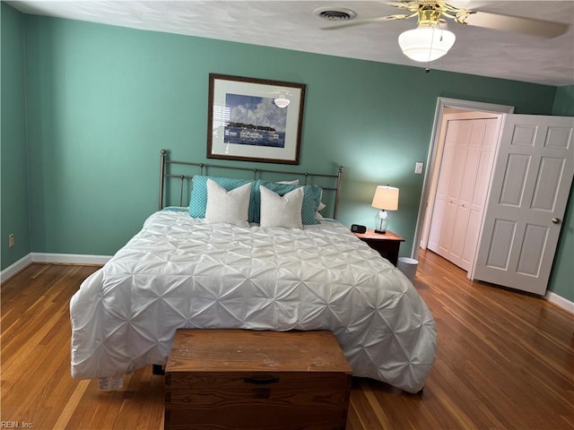 bedroom featuring a closet, hardwood / wood-style flooring, and ceiling fan