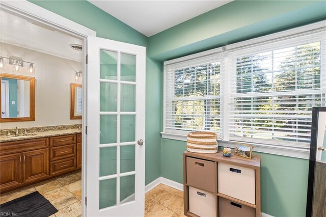 bathroom featuring vanity, plenty of natural light, and vaulted ceiling