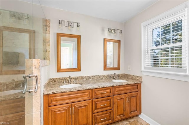 bathroom featuring a shower with door and vanity