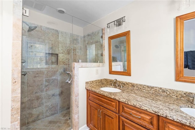 bathroom featuring vanity and a shower with shower door