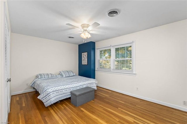 bedroom with ceiling fan and hardwood / wood-style flooring