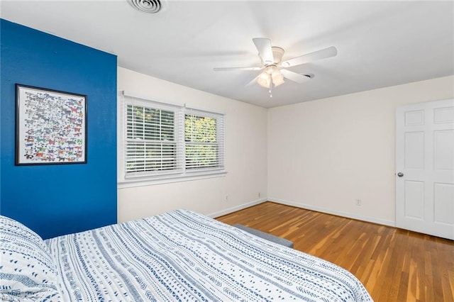 unfurnished bedroom with hardwood / wood-style floors and ceiling fan