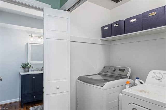 laundry area with washer and clothes dryer and dark hardwood / wood-style flooring