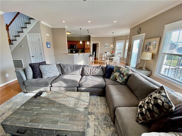 living room with hardwood / wood-style floors and crown molding