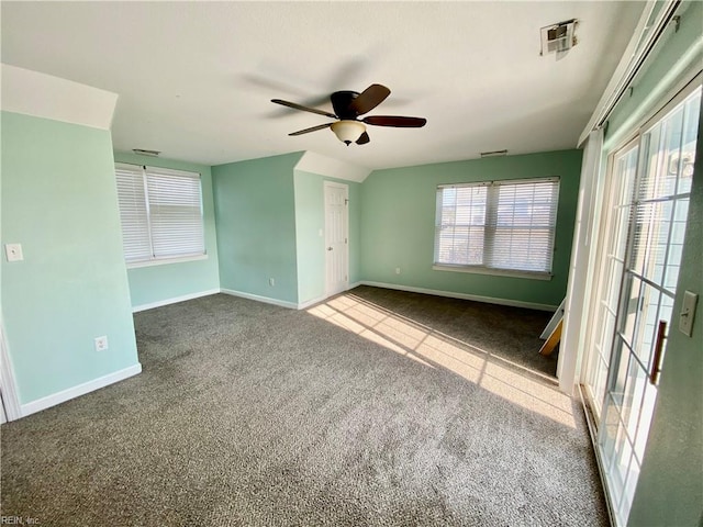 carpeted spare room with ceiling fan