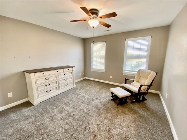 unfurnished room with ceiling fan and dark carpet