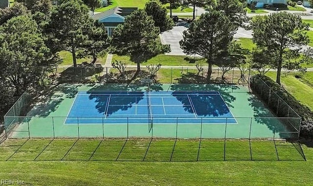 view of tennis court featuring a yard