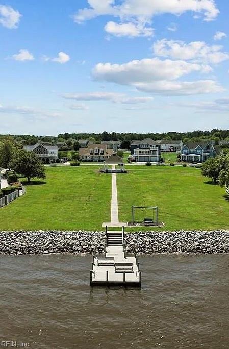 dock area with a water view and a yard