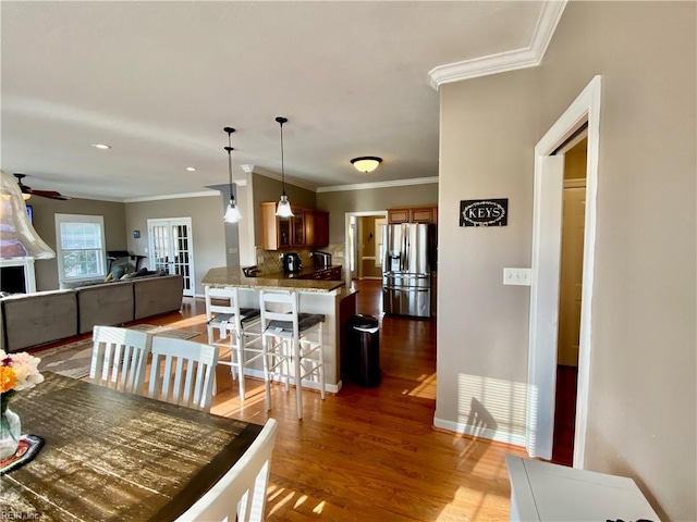 dining room featuring french doors, light hardwood / wood-style floors, and crown molding