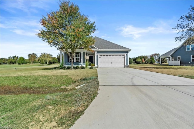 view of front of property featuring a front yard and a garage