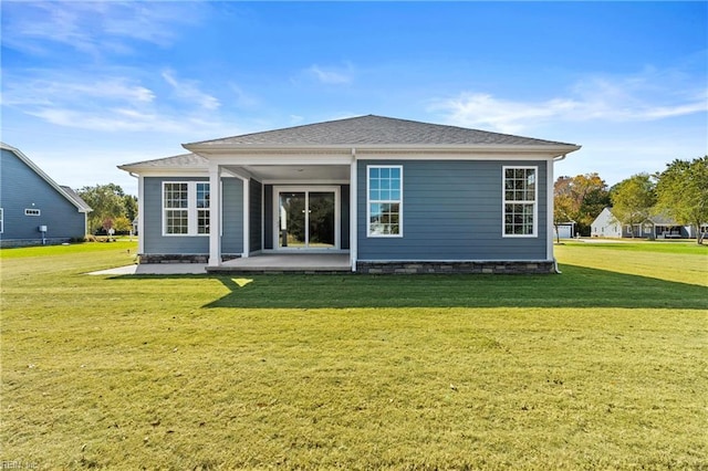 rear view of property featuring a patio area and a lawn