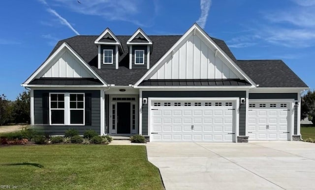 view of front of home featuring a garage and a front lawn