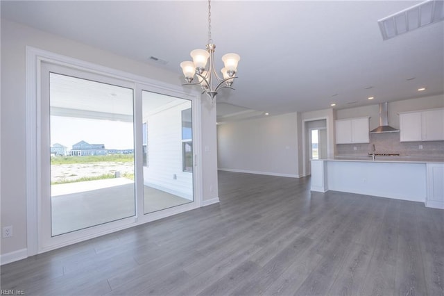 interior space featuring hardwood / wood-style floors, a healthy amount of sunlight, sink, and an inviting chandelier